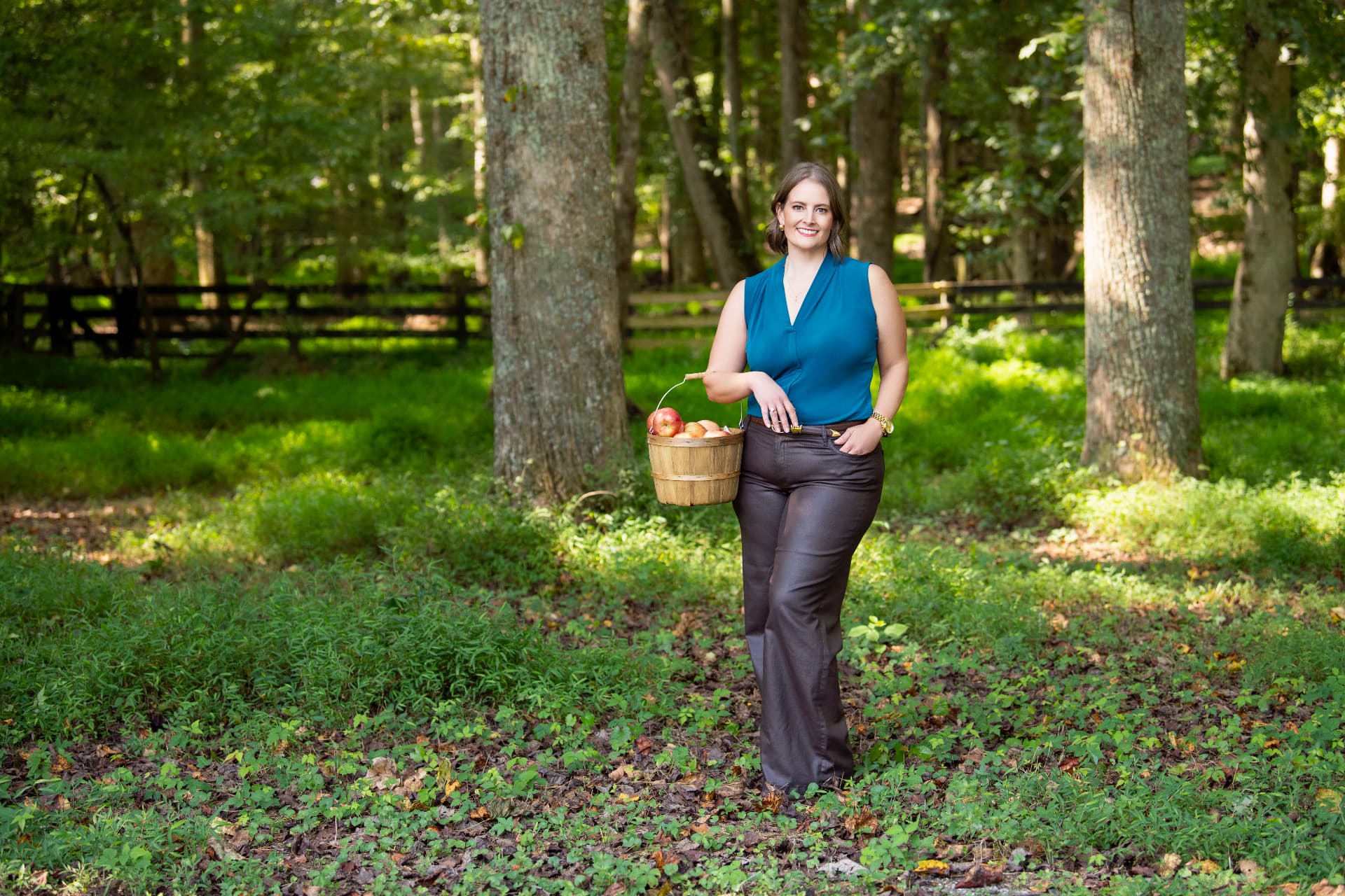 Melissa Moss walking a wooded path in soft afternoon light